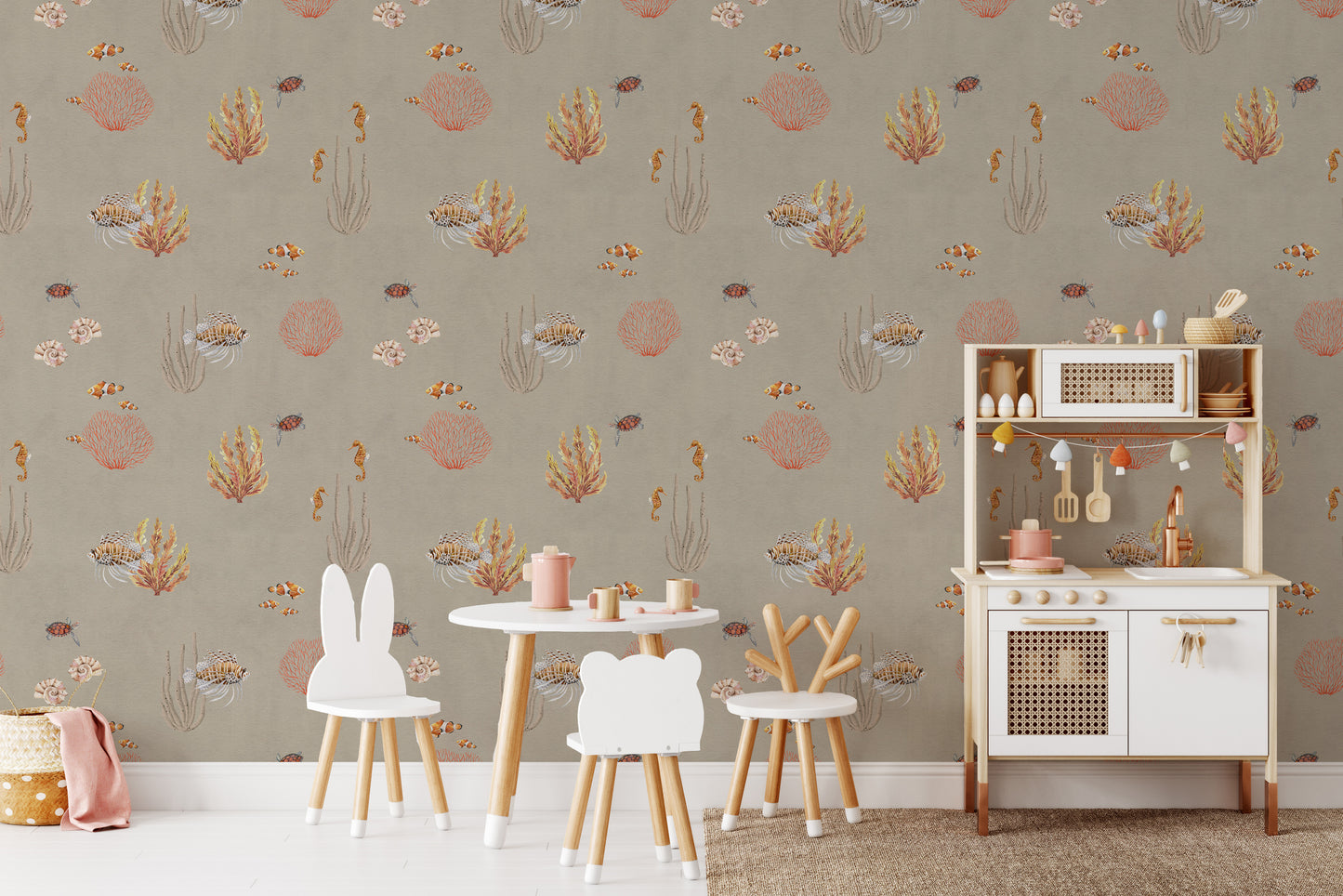 Brown Oceanic Wonders wallpaper beside a white play kitchen and bunny chairs in a kids room