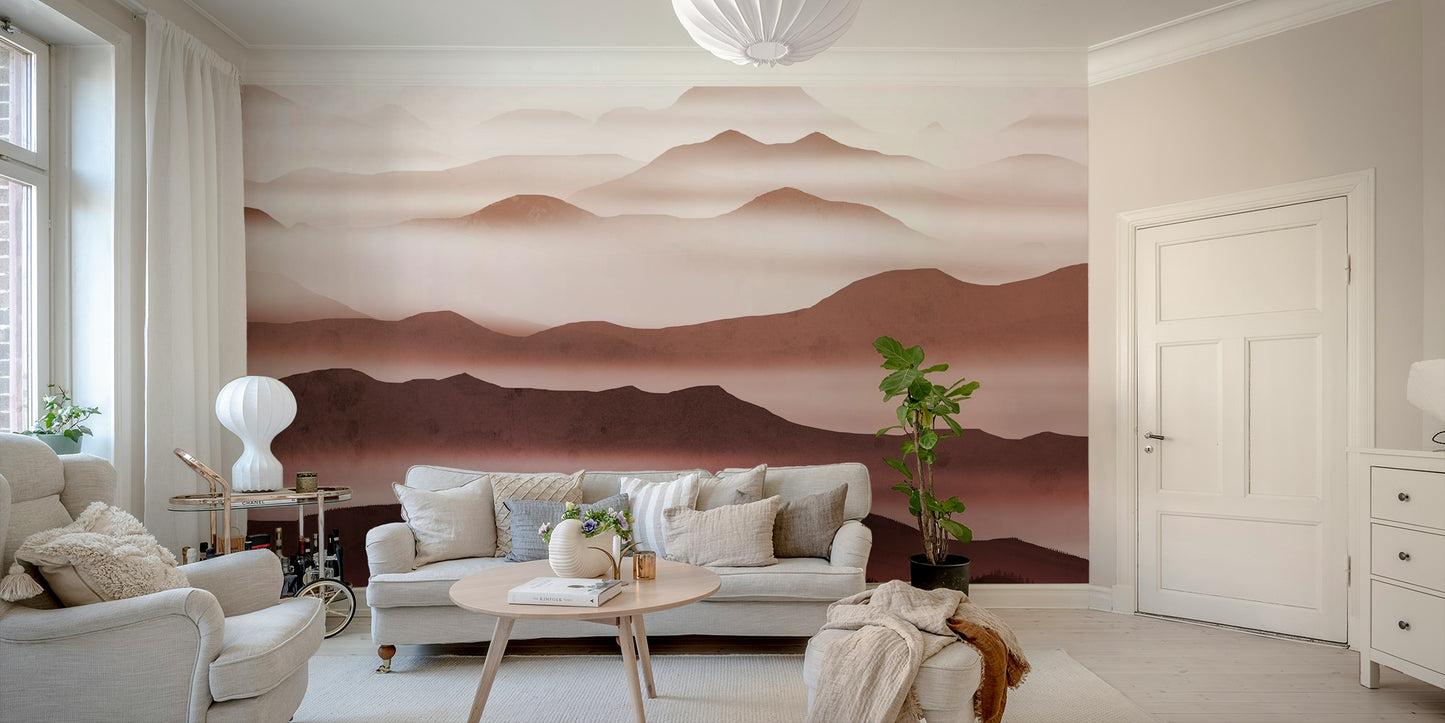 Burgundy Mountain Haze wallpaper of hazy burgundy mountains behind a cream sofa and fiddle-leaf plant in a living room