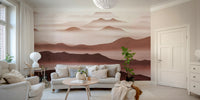 Burgundy Mountain Haze wallpaper of hazy burgundy mountains behind a cream sofa and fiddle-leaf plant in a living room