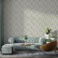 Buttercups Garden Golden and Gray wallpaper behind a sage green sofa and leather armchair in a living room