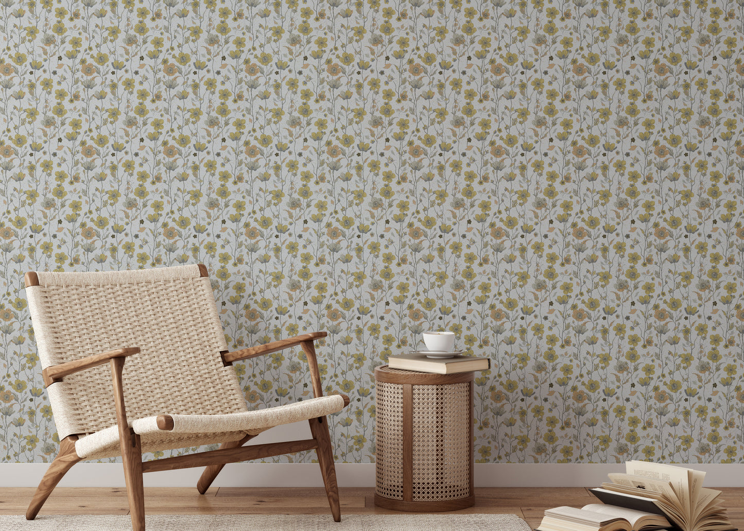 Buttercups Garden Golden and Gray wallpaper behind a woven rattan armchair and caned side table