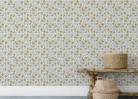 Buttercups Garden Golden and Gray wallpaper above a rustic wooden bench with seagrass baskets in an entryway