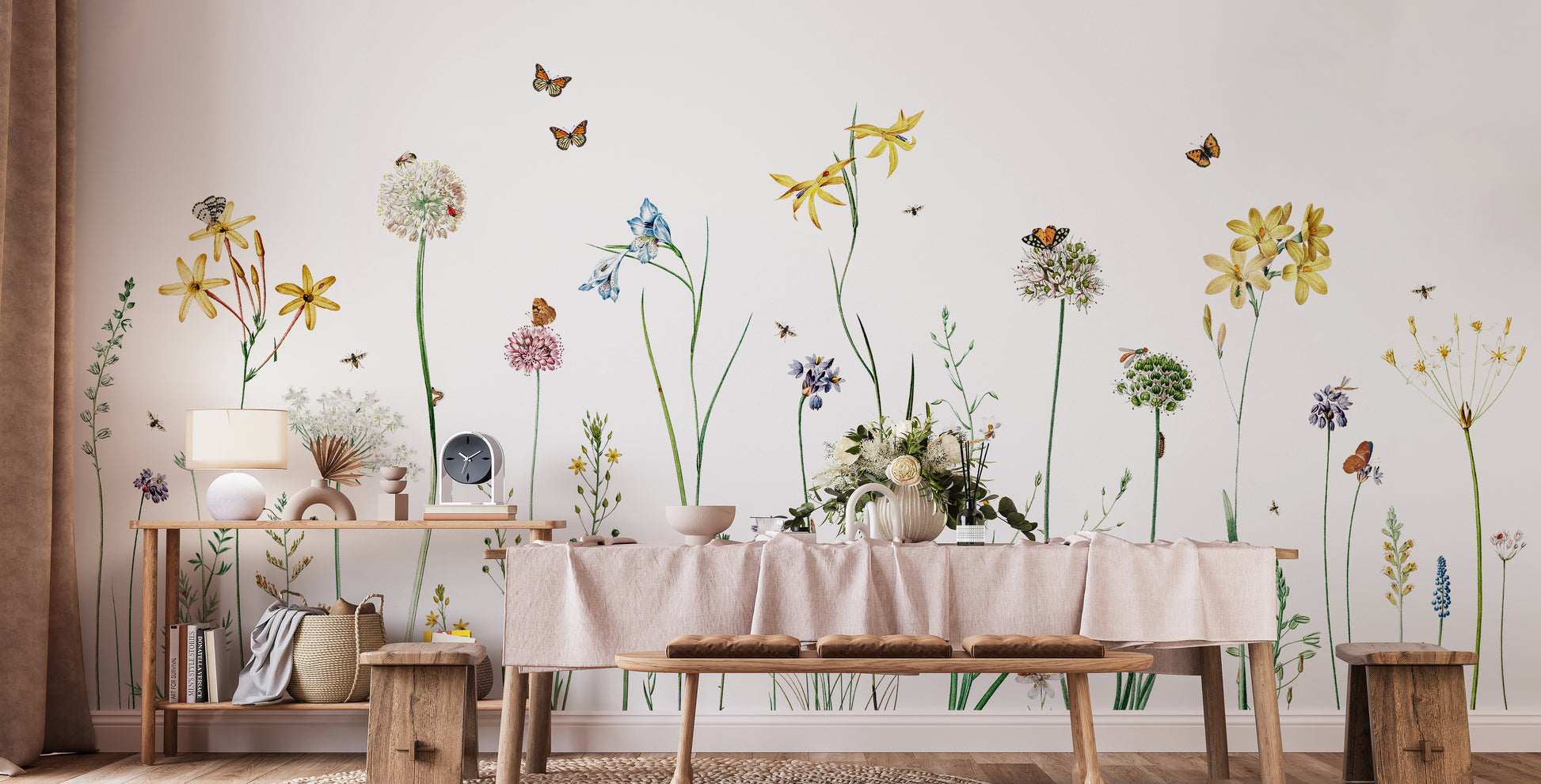 Butterfly Garden wallpaper mural of wildflowers and butterflies in a dining room behind a draped table and wood bench