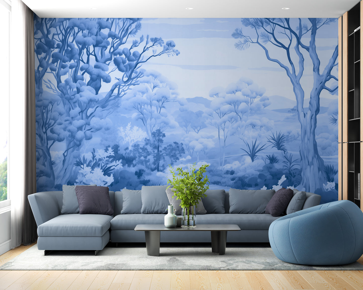 Autumn Forest Blue Color wallpaper mural of blue trees and hills behind a gray sectional and blue accent chair