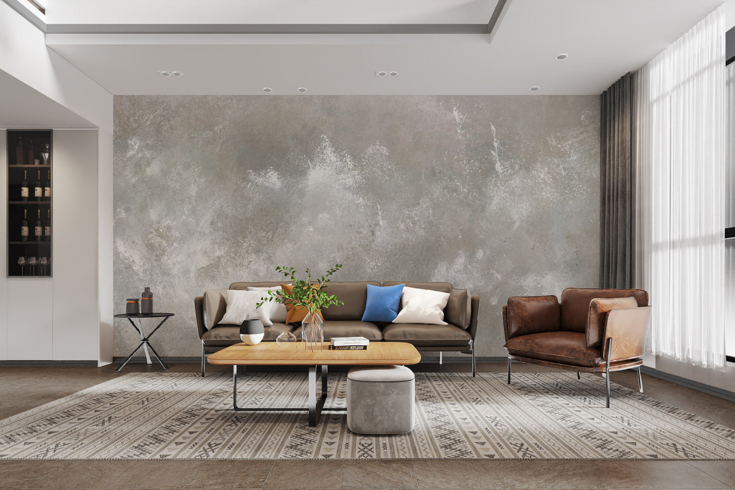 Baltic Sand Textured Abstract wallpaper mural in grey behind a brown leather sofa and patterned rug in a living room