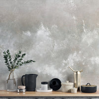Baltic Sand Textured Abstract wallpaper mural in pale grey behind a wood shelf with eucalyptus and ceramic jars, close styling