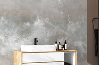 Baltic Sand Textured Abstract wallpaper mural in grey behind a white vessel sink on a wood vanity in a bathroom