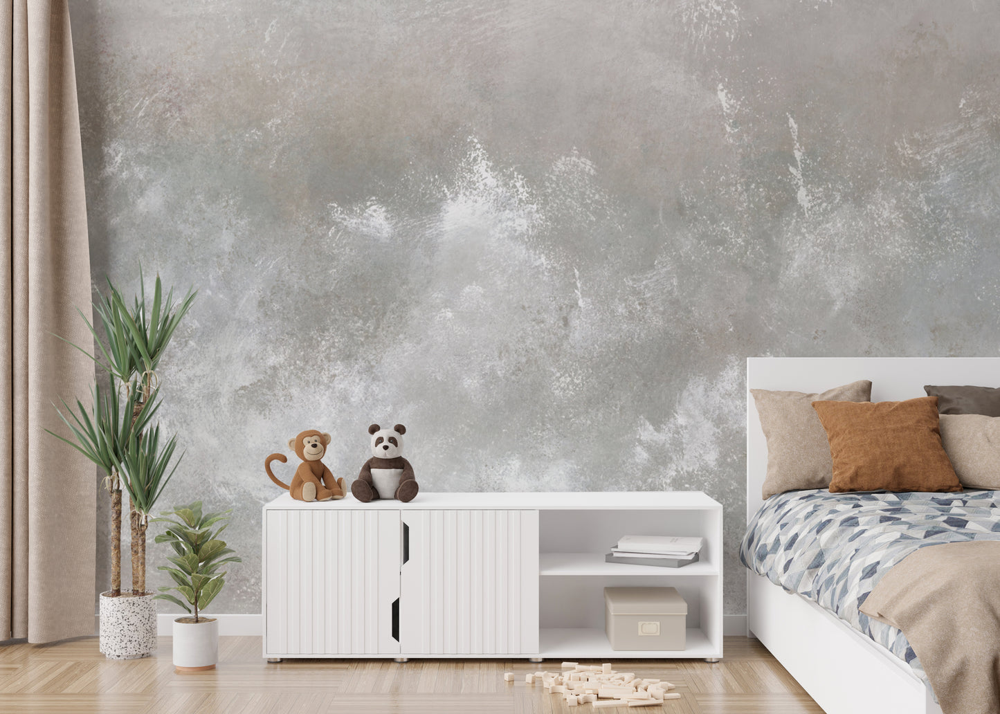 Baltic Sand Textured Abstract wallpaper mural in grey behind a white sideboard with plush toys and a bed in a kids bedroom