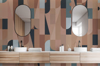 Chromatic Puzzle Wall mural in blush and blue geometric shapes behind a double vanity in a bathroom