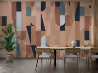 Chromatic Puzzle Wall mural in terracotta geometric shapes behind a wooden dining table and chairs