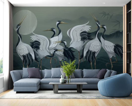 Elegant Crane Birds wallpaper mural styled as a living room feature wall behind a sofa and seating in black and white