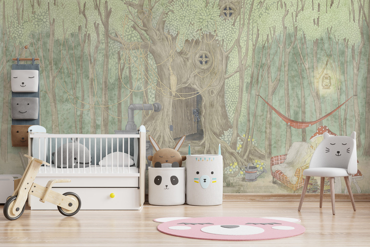 Fairyland Cascade mural of a green forest tree house behind a white crib and wooden balance bike in a nursery