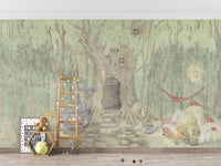 Fairyland Cascade mural of a green forest tree house behind a wooden ladder shelf and teddy bear in a kids room