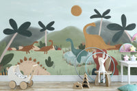 Gentle Giants dinosaur wallpaper mural behind a white toy pram and wooden bunny stool in a soft nursery