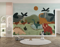 Gentle Giants wallpaper mural with green hills and a red triceratops beside alcove shelves and a round rug in a kids room