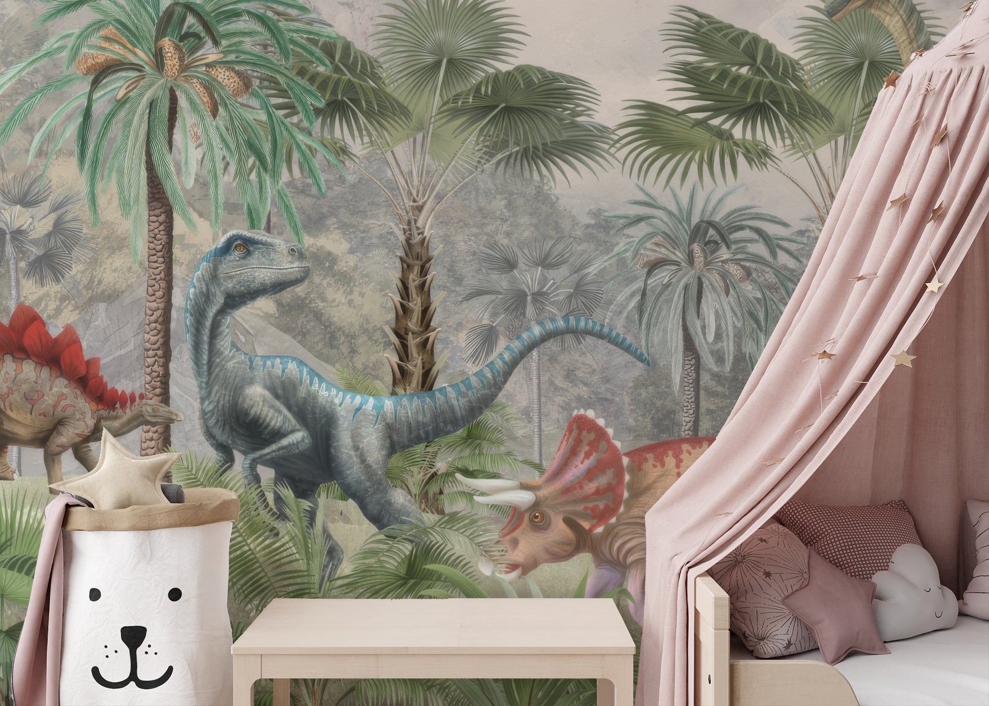 Mesozoic Mingle wallpaper mural of a blue raptor and triceratops behind a kids bed with a pink star canopy