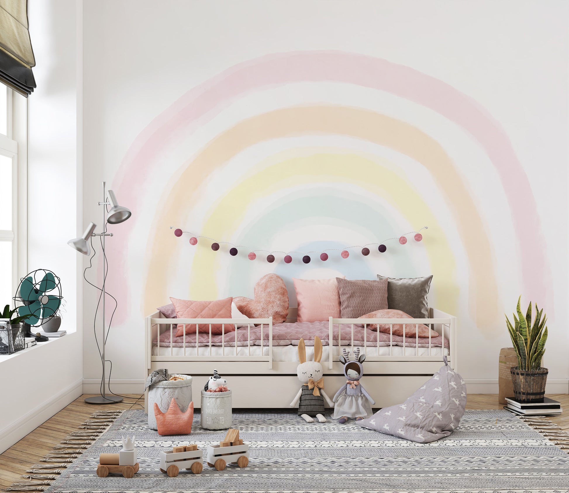 Pastel Rainbow wallpaper mural over a cream daybed with blush pillows, pom-pom garland and bunny plush in a kids room