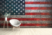 Standard Rustic Steel American Flag Wall Mural in a minimalist room with a white armchair and natural lighting.