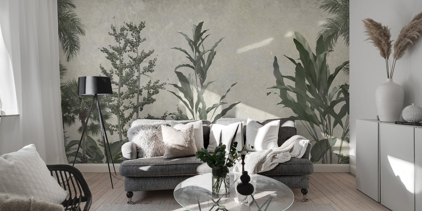 Verdant Valleys wallpaper mural of green trees and palms behind a grey sofa and black tripod floor lamp