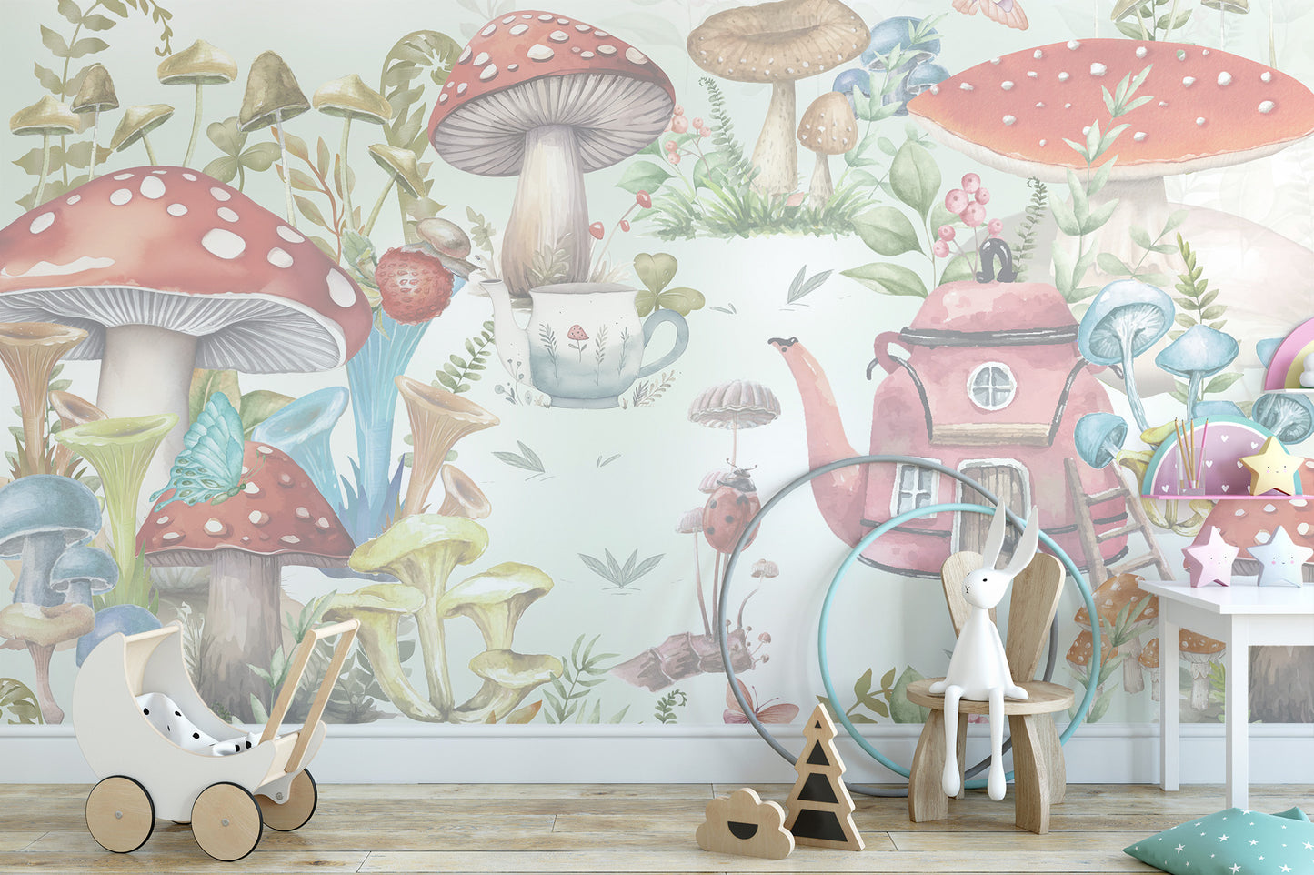 Whimsical Mushroom Garden wallpaper mural with toadstools and a pink teapot cottage behind a white toy pram and bunny chair