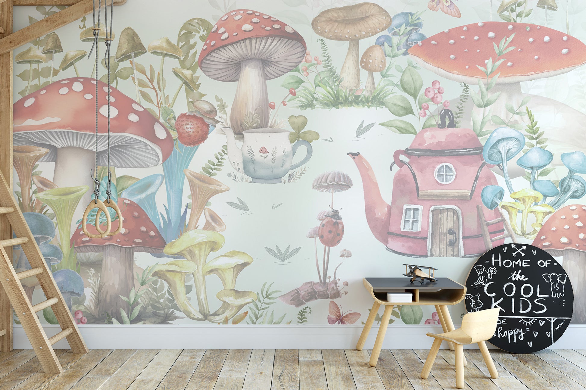Whimsical Mushroom Garden wallpaper mural with toadstools and a pink teapot cottage behind a black play desk in a kids room