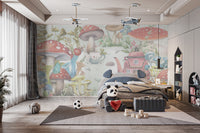 Whimsical Mushroom Garden wallpaper mural of red toadstools and a pink teapot house behind a grey bed with a panda plush