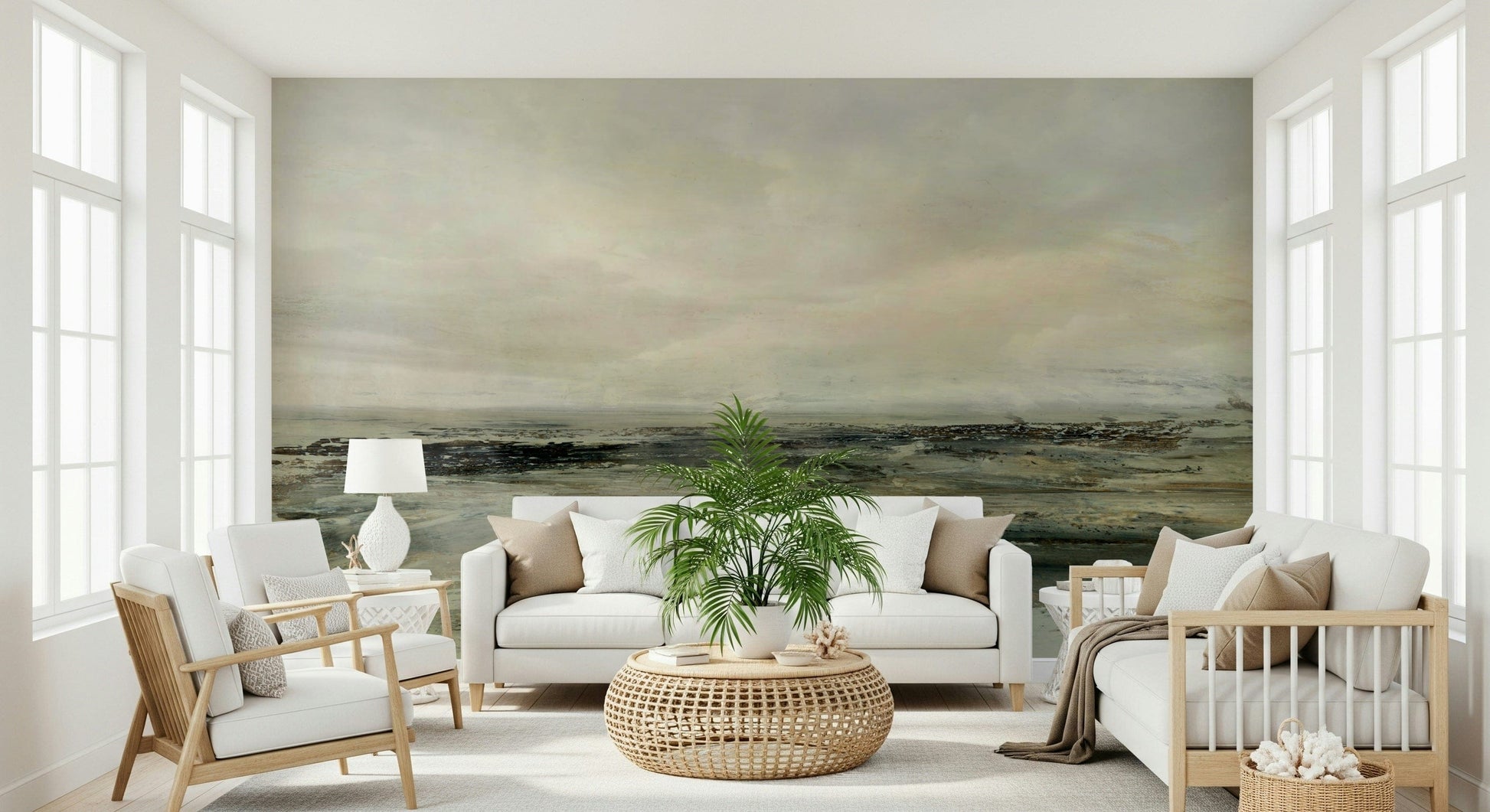 Coastal Hues wallpaper mural of a hazy green seascape behind a white sofa and rattan table in a bright sunroom