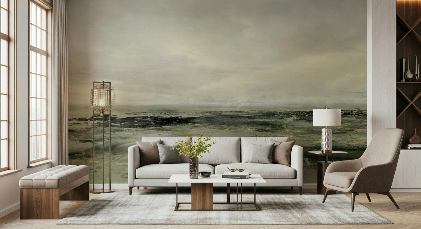 Coastal Hues wallpaper mural of a painterly green coast behind a cream sofa and brass floor lamp in a living room