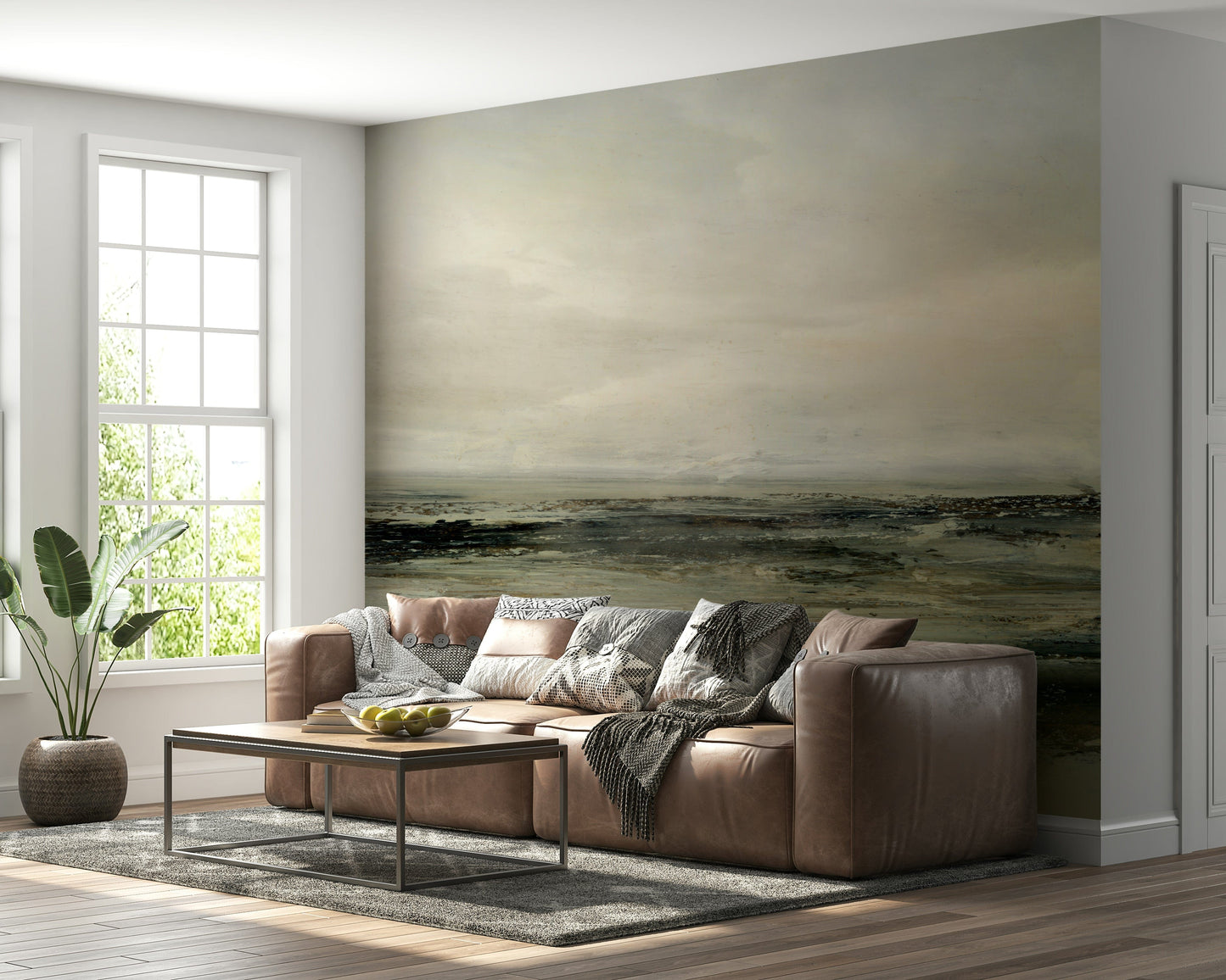 Coastal Hues wallpaper mural of an olive and brown shore behind a brown leather sectional sofa in a living room