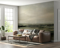 Coastal Hues wallpaper mural of an olive and brown shore behind a brown leather sectional sofa in a living room