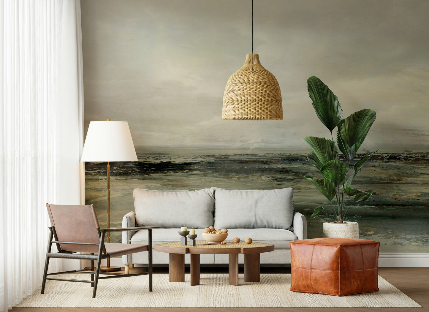 Coastal Hues wallpaper mural of a green seascape behind a grey sofa and terracotta leather pouf in a boho living room