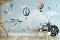 Hot Air Balloon Kids Room wallpaper mural styled as a feature wall behind a dining table and chairs in a multicolour palette