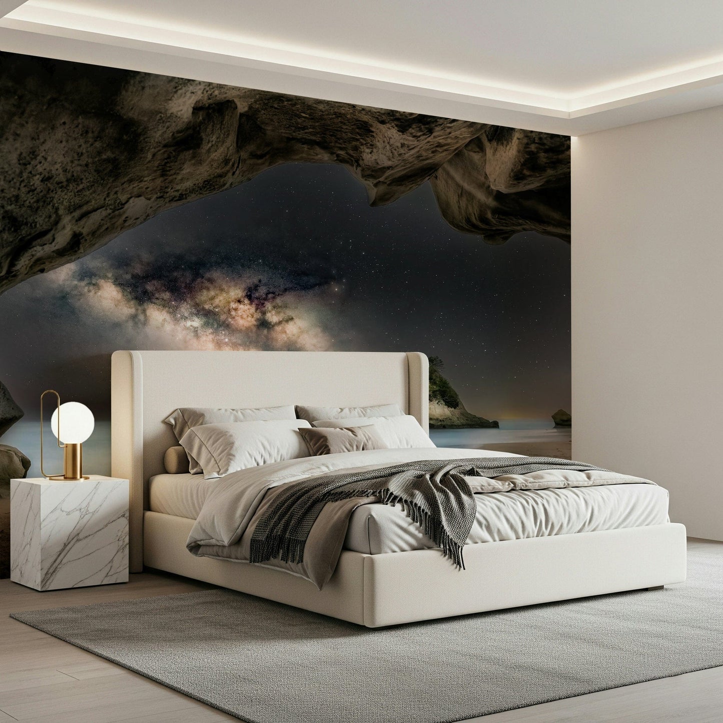 Cave Portal to Starlight wallpaper mural of a glowing galaxy in a sea cave above a cream bed in a modern bedroom