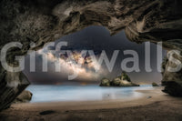 Cave Portal to Starlight wallpaper mural close-up showing the Milky Way glowing beyond a dark sea cave over a beach
