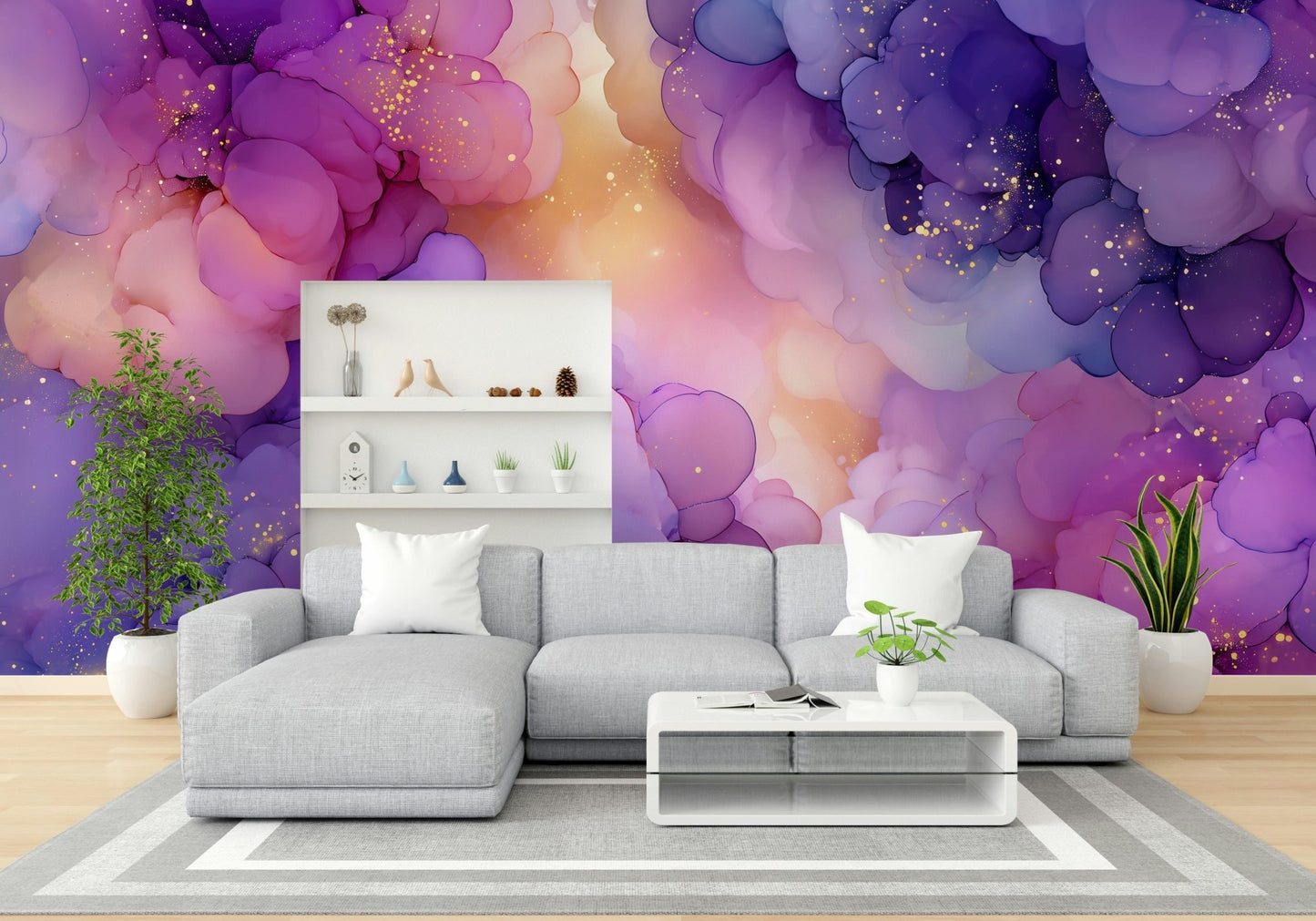 Celestial Cloudscape wallpaper mural in purple and pink ink clouds with gold flecks above a grey sectional sofa in a bright living room