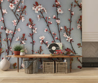 The wallpaper captures cherry blossoms with crisp detailing and warm reddish-brown stems.