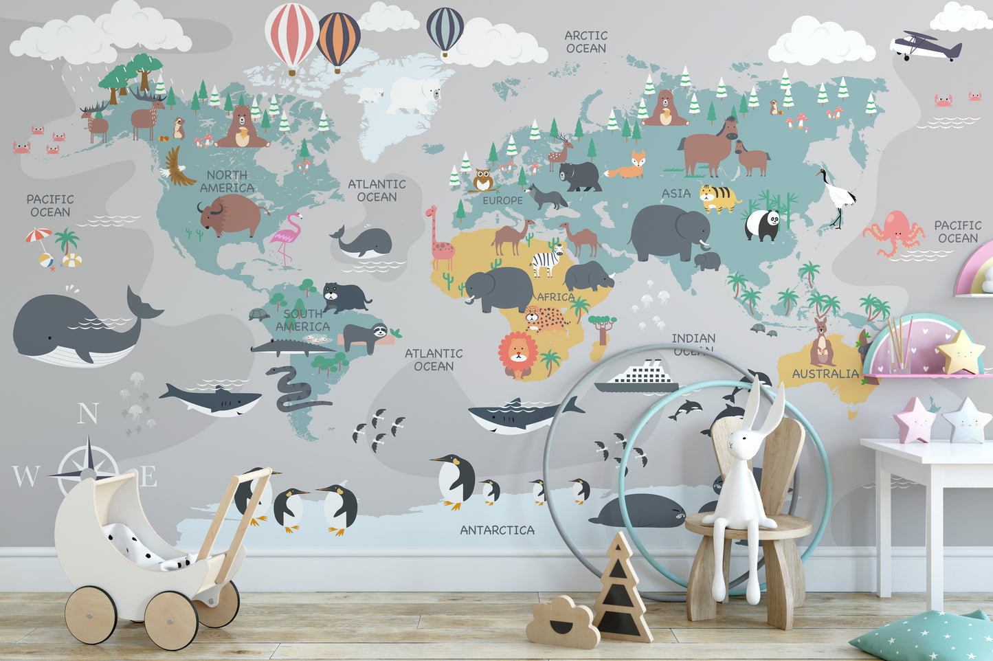 Children's World Map wallpaper in grey and blue above a toy pram and bunny chair in a child's playroom