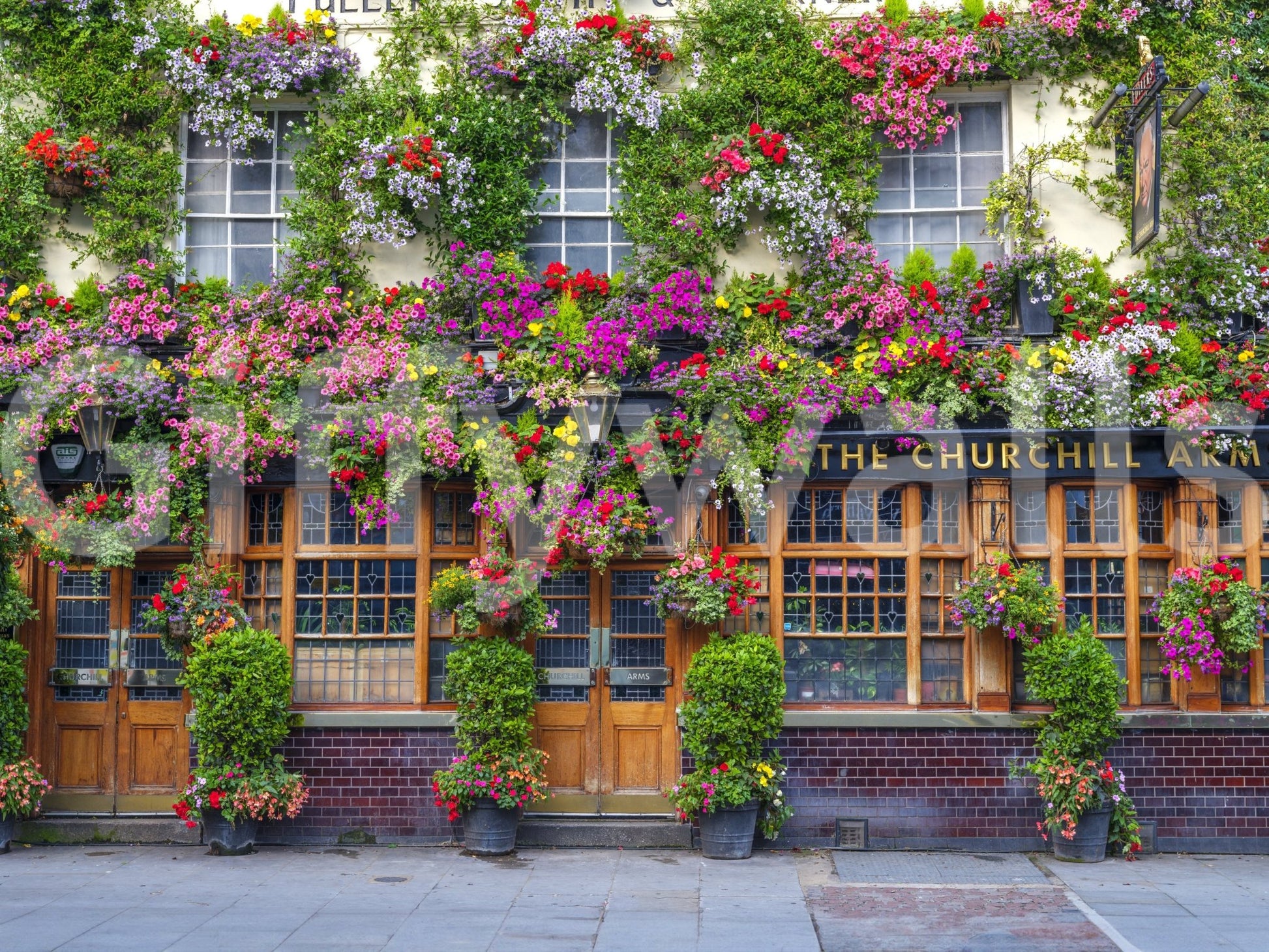 Inviting pub facade with bright floral wall mural

