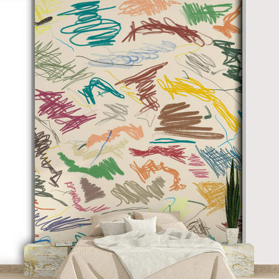 Cianfrusaglia wallpaper mural with colorful crayon scribbles on cream behind a low beige bed with white bedding in a bedroom