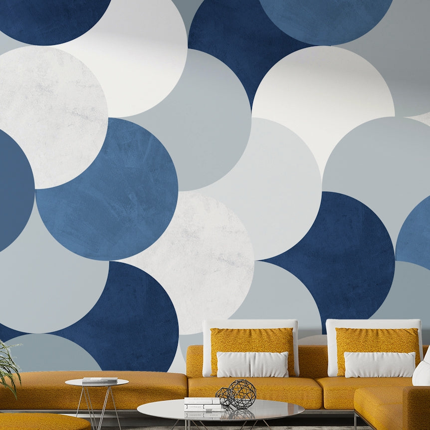 Circle Abstract wallpaper mural of blue and cream circles behind a mustard yellow sofa and white pillows