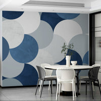Circle Abstract wallpaper mural of navy geometric circles behind a white round table and black and white chairs