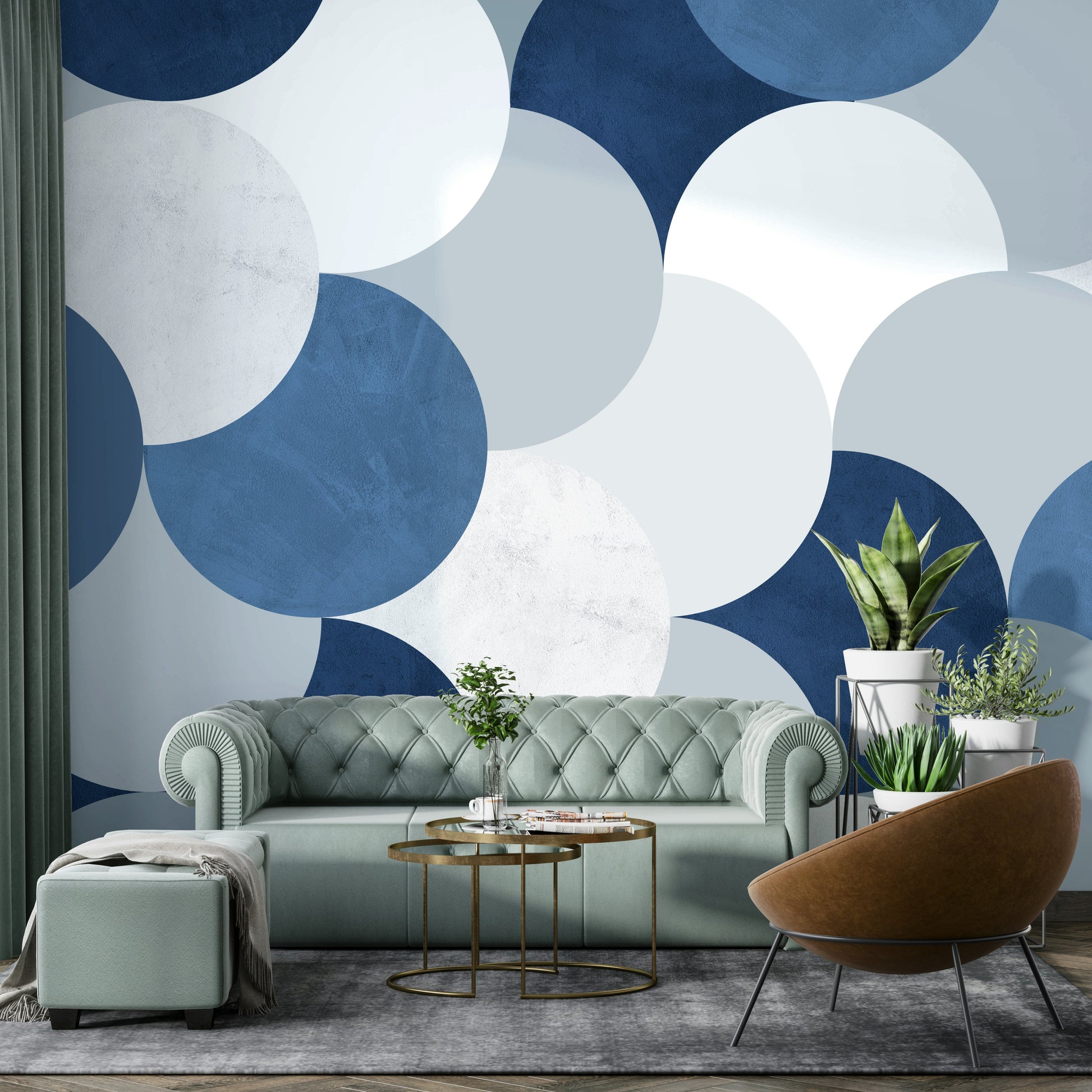 Circle Abstract wallpaper mural with navy circles behind a sage green chesterfield sofa and snake plants