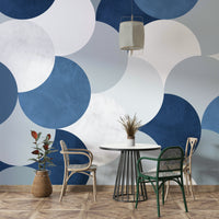 Circle Abstract wallpaper mural of blue and white circles behind a cafe table and rattan bistro chairs