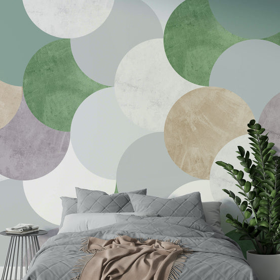 Circle Geometric Art wallpaper mural of sage green and beige circles behind a gray bed and tall ZZ plant