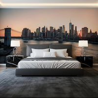 City Lights at Dawn wall mural of a glowing city skyline and bridge above a grey bed and black marble nightstands