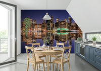 Night city skyline mural behind sofa, modern home styling for apartment living space