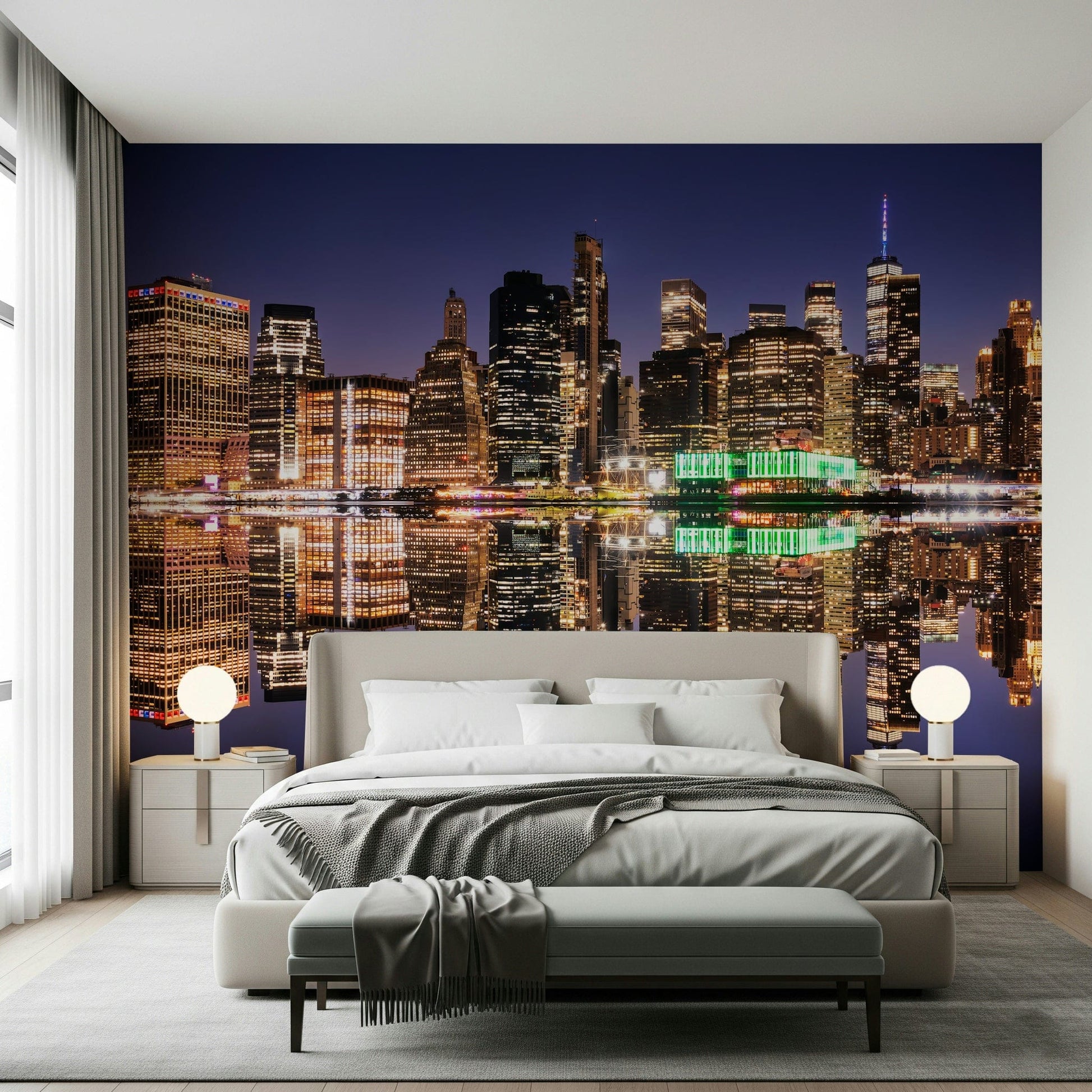 City night mural behind grey couch, skyline lights reflected on water