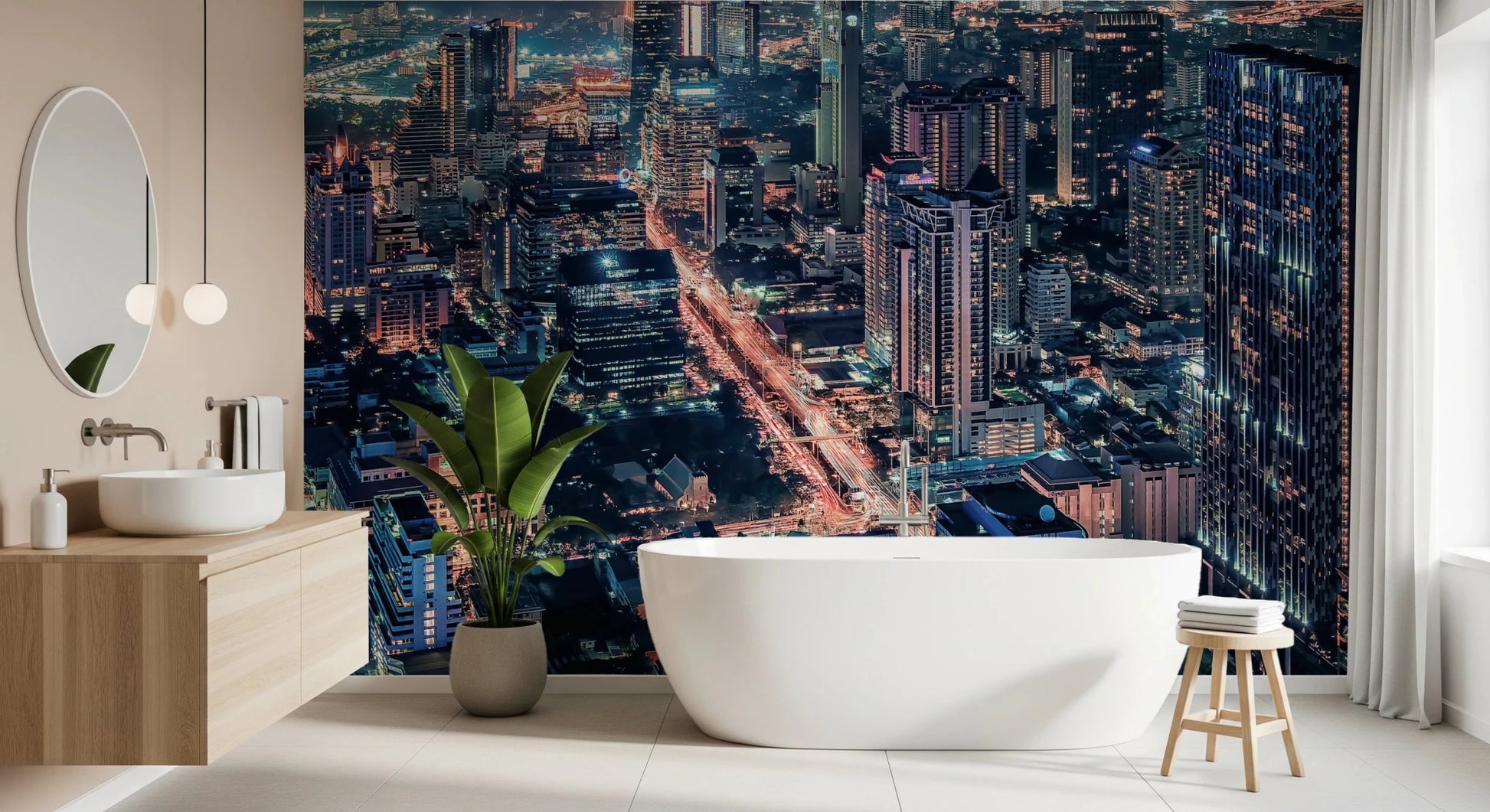 Cityscape Night wallpaper mural of an illuminated skyline in a bathroom with a freestanding white tub and plant