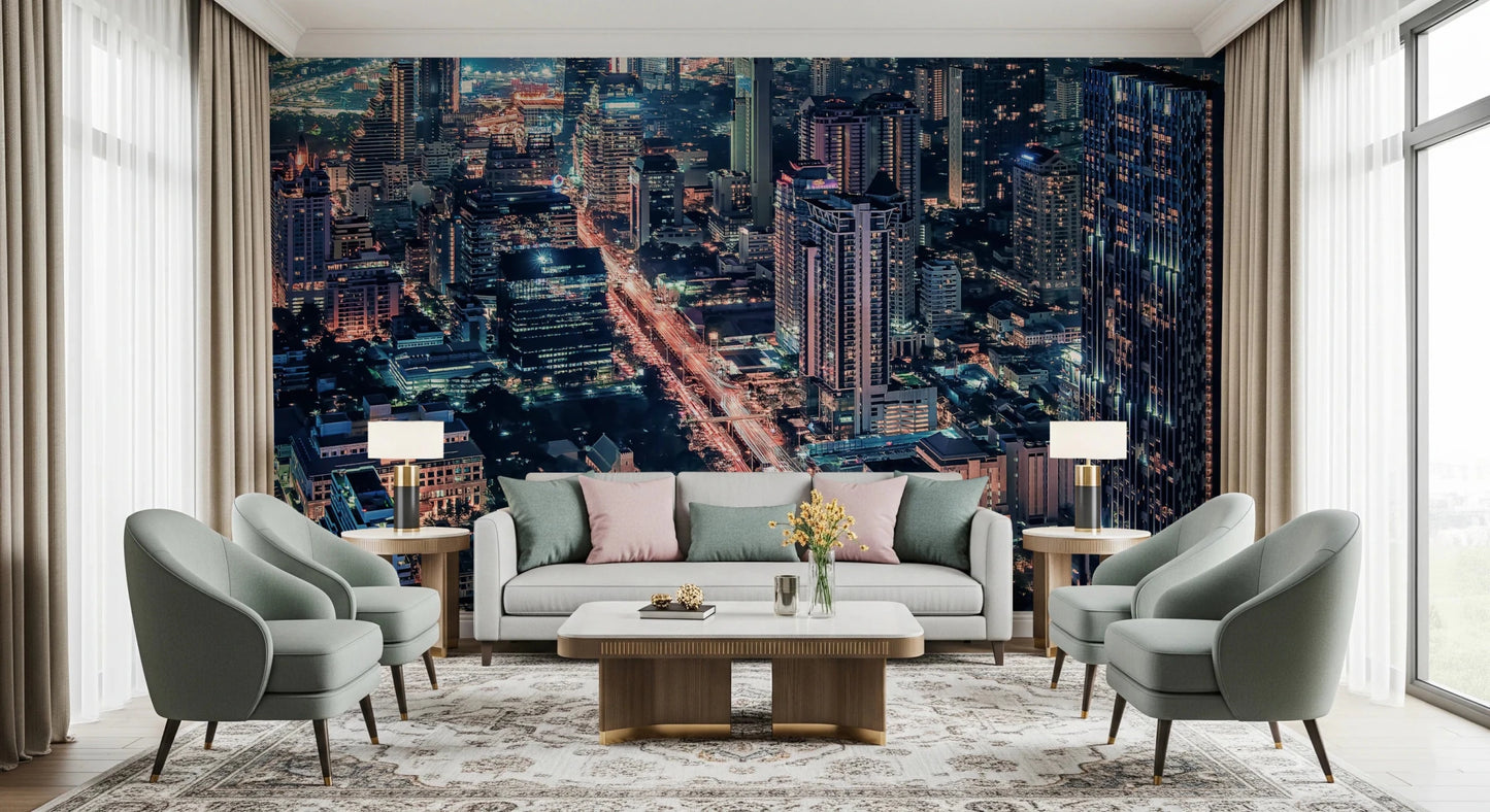 Cityscape Night wallpaper mural of a glowing nighttime city behind a gray sofa and sage green armchairs in a living room