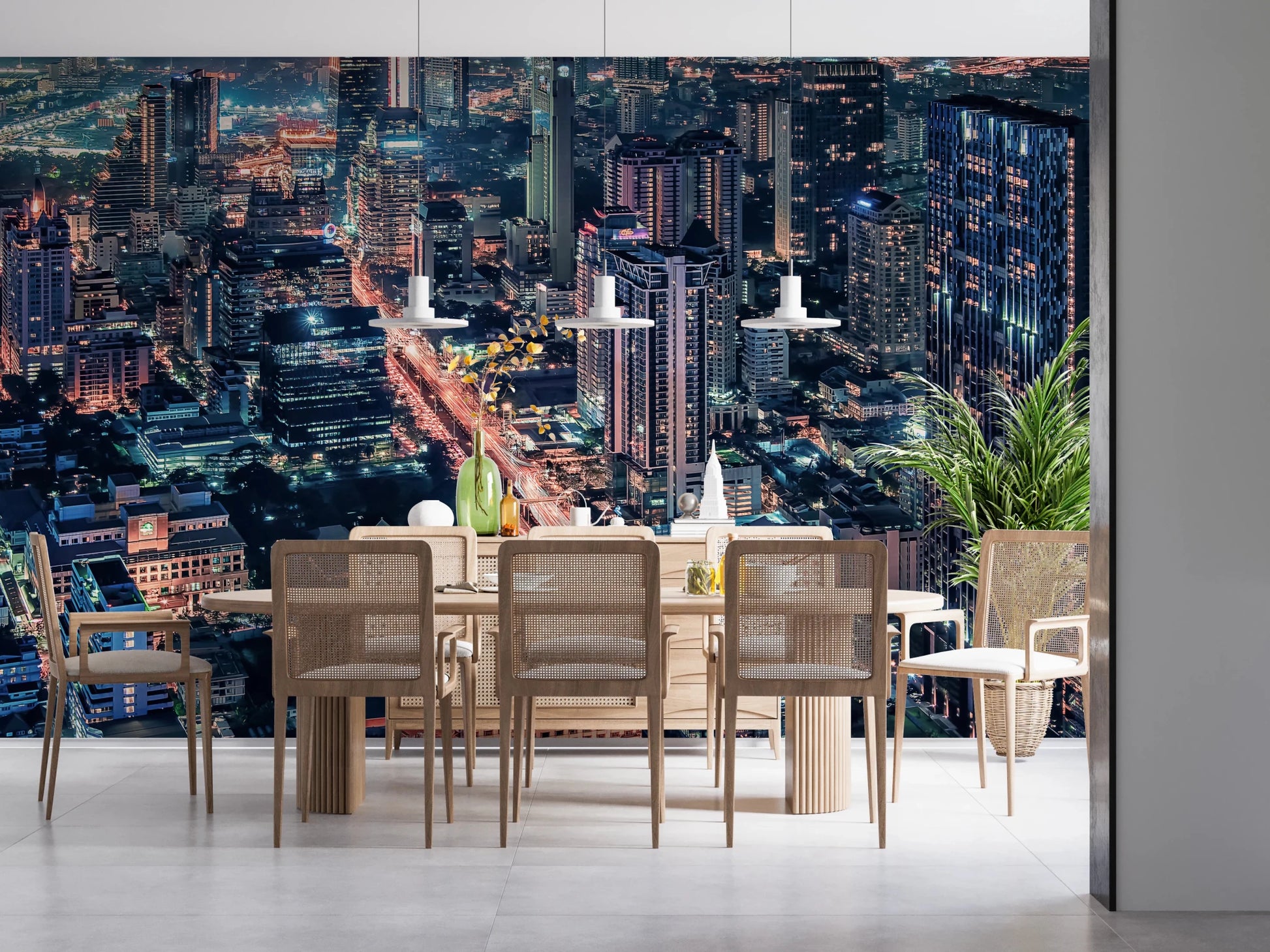 Cityscape Night wallpaper mural of an aerial skyline behind a light wood dining table with rattan chairs